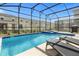 Private screened pool and spa with lounge chairs at 4370 Rhyme St, Kissimmee, FL 34746