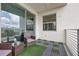 Private balcony with patio furniture and artificial turf at 4741 Clock Tower Dr # 306, Kissimmee, FL 34746