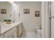 Double vanity bathroom with a large mirror and plenty of storage at 4741 Clock Tower Dr # 306, Kissimmee, FL 34746