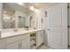 Double vanity bathroom with a large mirror and plenty of storage at 4741 Clock Tower Dr # 306, Kissimmee, FL 34746