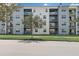 Apartment building exterior showcasing multiple balconies and a tree at 4741 Clock Tower Dr # 306, Kissimmee, FL 34746