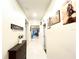 Bright hallway with coat rack and decorative wall art at 4741 Clock Tower Dr # 306, Kissimmee, FL 34746