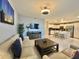 Open living area with modern kitchen and dining at 4741 Clock Tower Dr # 306, Kissimmee, FL 34746