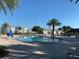 Community pool with surrounding patio furniture at 4741 Clock Tower Dr # 306, Kissimmee, FL 34746