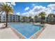 Community pool with plenty of lounge chairs at 4741 Clock Tower Dr # 306, Kissimmee, FL 34746