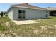 The backyard features a small patio and sliding glass doors to the home at 505 Pentas Ln, Haines City, FL 33844