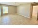 The bedroom features neutral paint, a window with blinds, and tiled flooring for easy cleaning at 505 Pentas Ln, Haines City, FL 33844