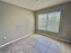 Neutral bedroom with tile floors and a bright window for natural light at 505 Pentas Ln, Haines City, FL 33844