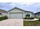 One-story home with attached garage and landscaped front yard at 505 Pentas Ln, Haines City, FL 33844