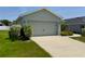 Charming single-story home featuring an attached two-car garage, landscaped front yard and a concrete driveway at 505 Pentas Ln, Haines City, FL 33844