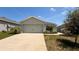 Charming single-story home featuring an attached two-car garage, landscaped front yard and a concrete driveway at 505 Pentas Ln, Haines City, FL 33844