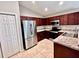 Modern kitchen featuring stainless steel appliances and dark wood cabinets at 505 Pentas Ln, Haines City, FL 33844