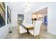 Modern dining room with marble table and kitchen view at 5454 Rishley Run Way, Mount Dora, FL 32757