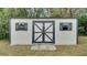 The outdoor shed has painted siding, black trim, shutters, and a double door at 616 Se 31St Ter, Ocala, FL 34471