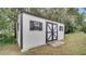 White shed with black trim and double doors at 616 Se 31St Ter, Ocala, FL 34471