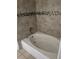 Bathroom with tub and tiled walls at 6413 Astor Village # 210, Orlando, FL 32835
