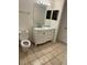 Bathroom with white vanity, marble top, and tiled floor at 6413 Astor Village # 210, Orlando, FL 32835