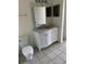 Bathroom with white vanity, marble top, and tiled floor at 6413 Astor Village # 210, Orlando, FL 32835