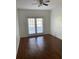 Bright bedroom with hardwood floors and French doors at 6413 Astor Village # 210, Orlando, FL 32835