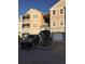 Building exterior with parking and landscaping at 6413 Astor Village # 210, Orlando, FL 32835