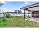 Fenced backyard with covered patio and grassy area at 667 Heraldo Ct, Kissimmee, FL 34758