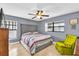 Grey walls, king bed, and a yellow accent chair at 667 Heraldo Ct, Kissimmee, FL 34758