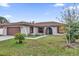 Single-story house with attached garage and well-manicured lawn at 667 Heraldo Ct, Kissimmee, FL 34758