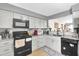 Modern kitchen with granite countertops and stainless steel appliances at 667 Heraldo Ct, Kissimmee, FL 34758