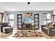Spacious living room featuring comfortable seating and large TV at 667 Heraldo Ct, Kissimmee, FL 34758