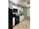 Modern kitchen with white cabinets and black appliances at 710 Michigan Ct # 2, St Cloud, FL 34769