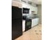 Modern kitchen features black appliances and white cabinets at 710 Michigan Ct # 2, St Cloud, FL 34769