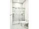 Modern bathroom with marble shower and toilet at 8296 Portofino Dr # 102, Davenport, FL 33896