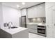 Modern kitchen with white cabinets and quartz countertops at 8296 Portofino Dr # 102, Davenport, FL 33896