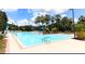 Refreshing community swimming pool with ample lounge chairs at 8296 Portofino Dr # 102, Davenport, FL 33896