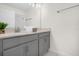 Double vanity bathroom with gray cabinets and a granite countertop at 8985 Stinger Dr, Davenport, FL 33896