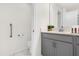 Modern bathroom with gray vanity, a toilet and a shower at 8985 Stinger Dr, Davenport, FL 33896