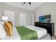 Spacious bedroom with dresser, TV and soft textiles at 8985 Stinger Dr, Davenport, FL 33896