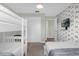 Bedroom with bunk beds, double bed, and rainbow wall at 8985 Stinger Dr, Davenport, FL 33896