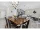 Bright dining room with kitchen views and modern chandelier at 8985 Stinger Dr, Davenport, FL 33896