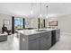 Modern kitchen with large island, stainless steel appliances, and gray cabinets at 8985 Stinger Dr, Davenport, FL 33896