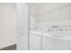 Bright laundry room with washer and dryer and shelving at 8985 Stinger Dr, Davenport, FL 33896