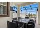 Covered patio with pool table and seating overlooking refreshing pool at 8985 Stinger Dr, Davenport, FL 33896