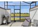 Relaxing screened patio with grill and lounge chair overlooking the lake at 8985 Stinger Dr, Davenport, FL 33896