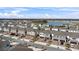 Aerial view of townhouses with attached garages and a community lake at 1254 Wispy Cypress Dr, Kissimmee, FL 34746