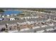 Aerial view showcasing townhouses, lake, and surrounding landscape at 1254 Wispy Cypress Dr, Kissimmee, FL 34746