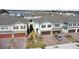 Aerial view of townhouses with attached garages, community lake, and landscaping at 1254 Wispy Cypress Dr, Kissimmee, FL 34746