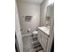 Clean bathroom with a white vanity, toilet and grey tile floor at 1254 Wispy Cypress Dr, Kissimmee, FL 34746