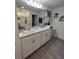 Bathroom with double vanity and large mirror at 1254 Wispy Cypress Dr, Kissimmee, FL 34746