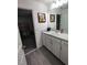 Simple bathroom with vanity, sink, and view into adjacent room at 1254 Wispy Cypress Dr, Kissimmee, FL 34746