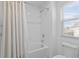 Clean bathroom with bathtub, shower, and window with blinds at 1254 Wispy Cypress Dr, Kissimmee, FL 34746